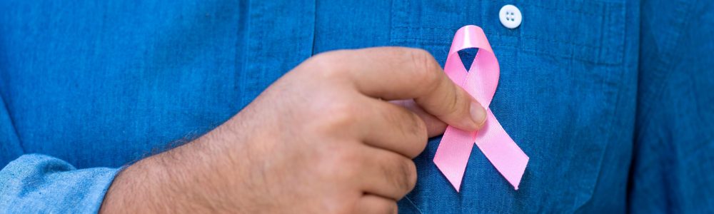 man with pink ribbon for supporting people living and illness,  Breast Cancer Awareness concept